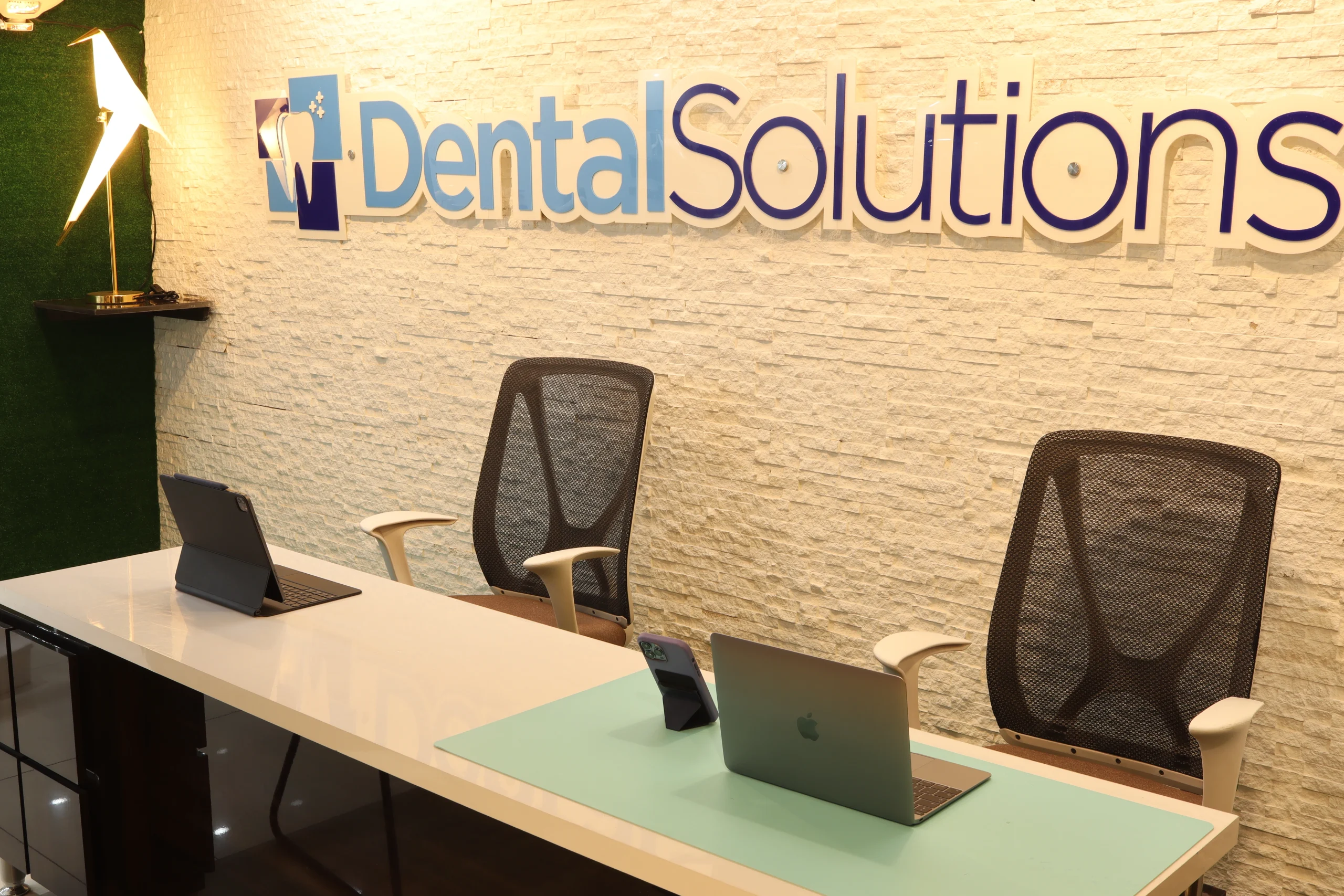 Dr. Umer Arshad consulting a patient at Dental Solutions in Sargodha.